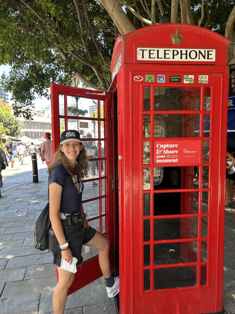 A holiday photo of me stepping into a red telephone box